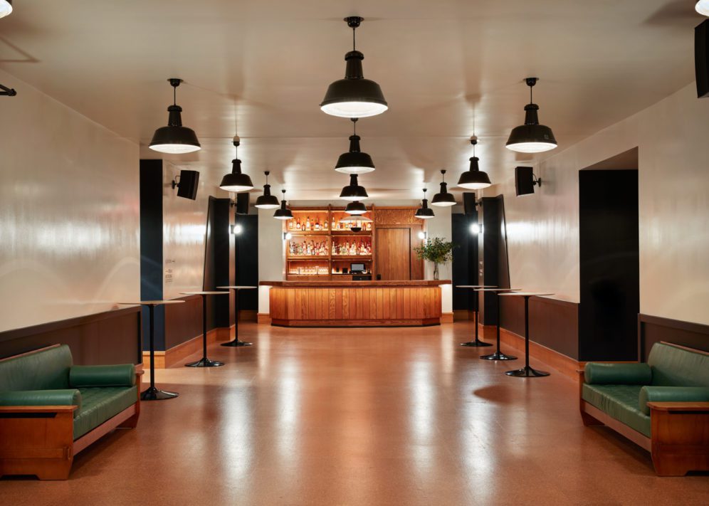 A low ceiling venue with studio style lights and built in seating provides a good place for an intermission or set change