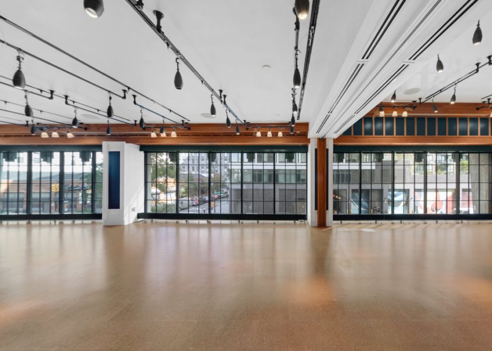 A low ceiling venue with studio style lights and floor to ceiling windows provides a place for gathering