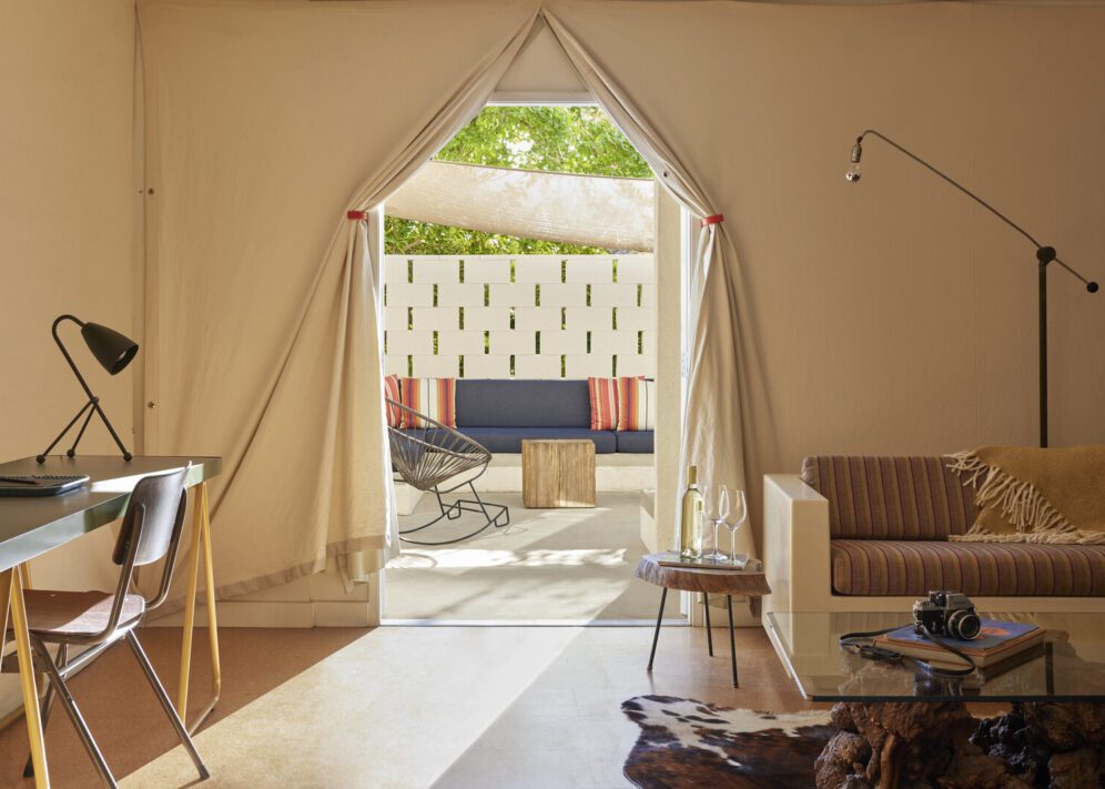 a canopy door is flanked by a couch