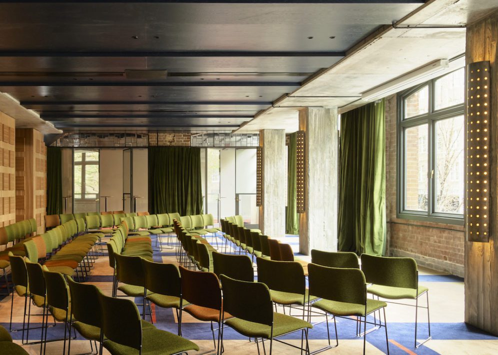 An event space with patterned flooring features windows that provide natural light and plenty of entry and exit points