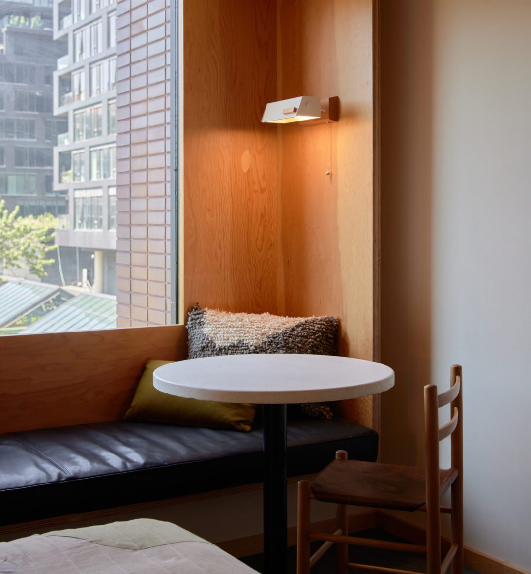 A black leather seating area is next to a table; plush cushions provide added comfort